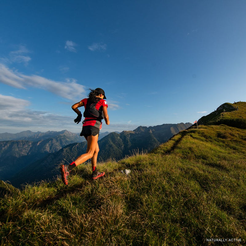 Woman trail running in the mountains
